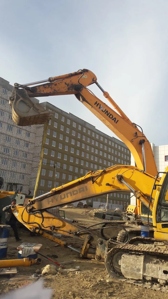 An excavator helps its wounded brother. Nature is beautiful! - Building, Humor