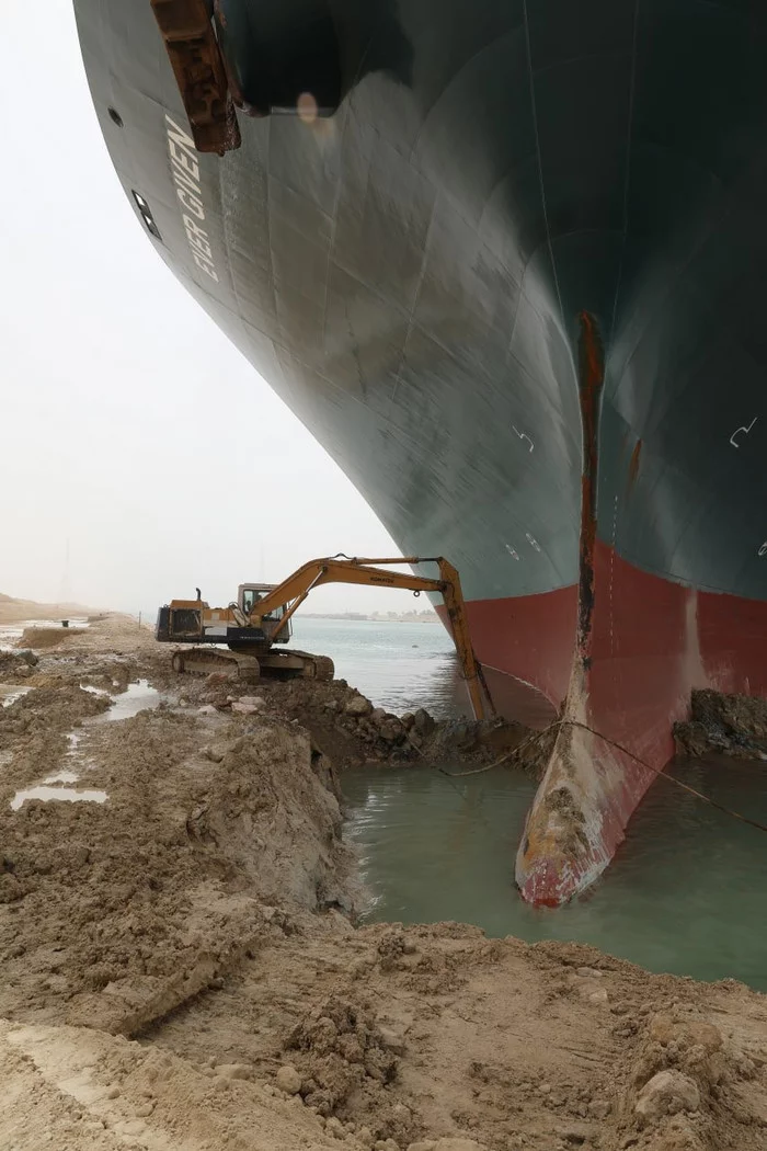 A small excavator is saving the world economy - Excavator, Container, Stuck, Suez canal, Ever Given container ship