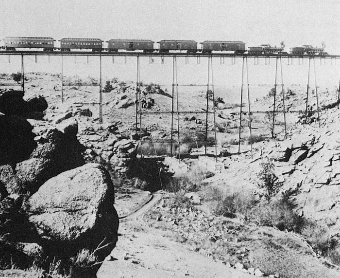 Train crosses the iron viaduct of Dale Creek in Wyoming, 1860 - Viaduct, A train, Bridge, Reliability, Black and white photo, Story