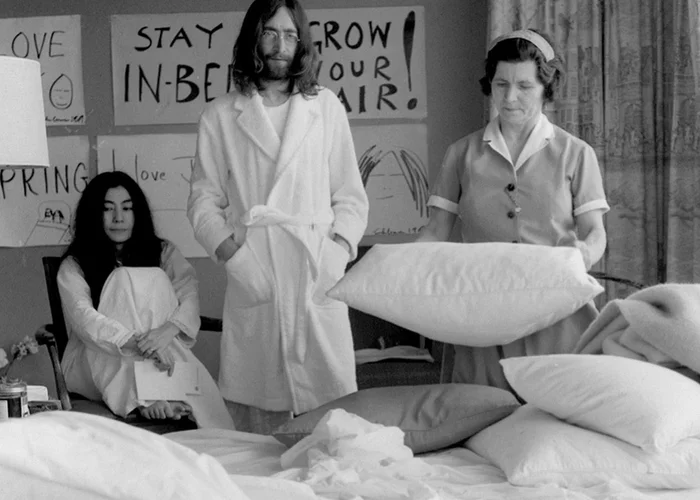 Yoko Ono and John Lennon wait for the maid to make the bed to continue rebelling against the system. - John Lennon, Yoko Ono, Retro, Hotel, Housemaid