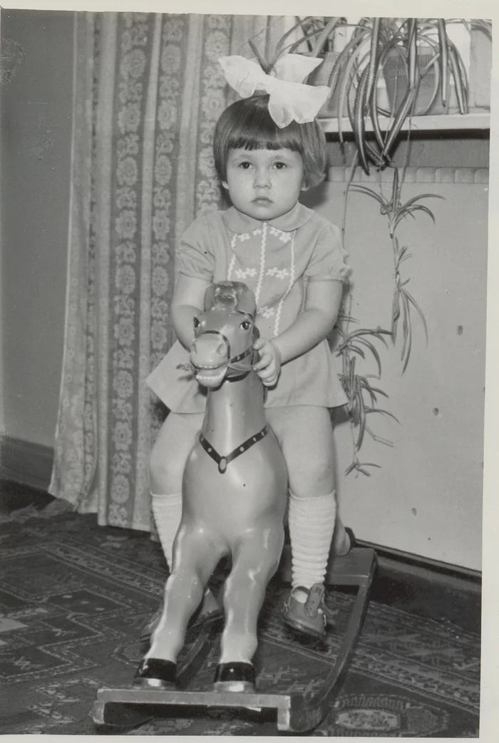 Where is this prince on a white horse? - My, Black and white photo, Retro, Kindergarten, Girl, Toy horse, Bow, Childhood in the USSR, 70th, Sandals, Knee socks, The dress, Carpet, Children's rocking chair